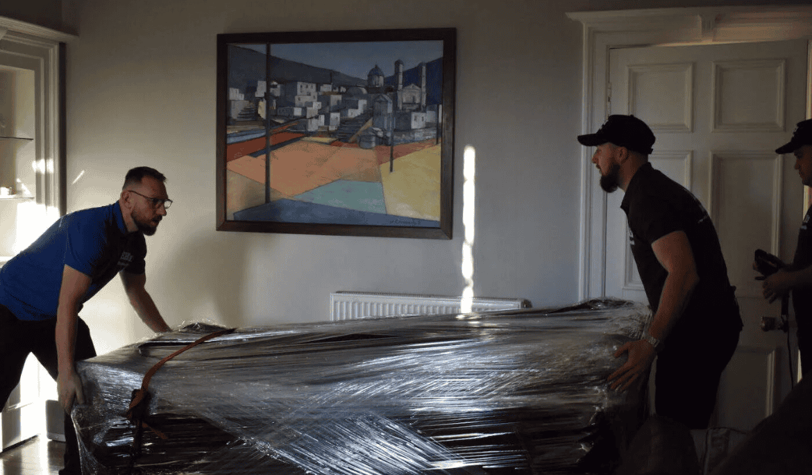 EH1 Removals wrapping furniture during a house removal